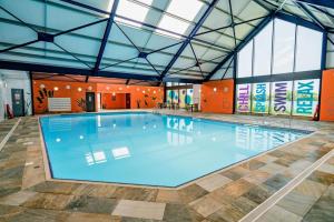 a large swimming pool in a large building at 3 bedroom Heaven Home in Chichester