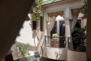 a house with a balcony with flowers on it at Riad Arabesque in Marrakech