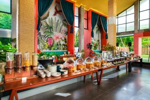 a row of tables filled with pots and pans at Tolani Resort Koh Samui in Lamai +61 photos