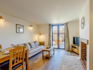 a living room with a couch and a table at Knoll Cottage - Uk31171 in Brent Knoll +10 photos