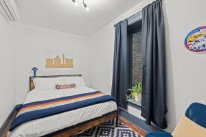 a bedroom with a bed and a window at 2BR Capitol hill delight, with private parking in Washington