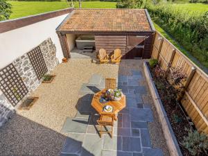 an overhead view of a patio with a table and chairs at Knoll Cottage - Uk31171 in Brent Knoll