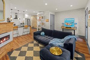 a living room with a couch and a fireplace at 2BR Capitol hill delight, with private parking in Washington, D.C.