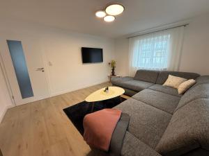 a living room with a couch and a table at Ferienwohnungen Bella in Reutte