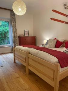 a bedroom with a large bed with a red blanket at Springhouse in Bad Gastein