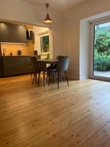 a kitchen and dining room with a table and chairs at Springhouse in Bad Gastein