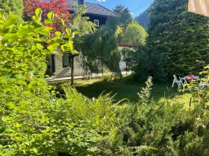 a view of a garden with a table and chairs at Springhouse in Bad Gastein