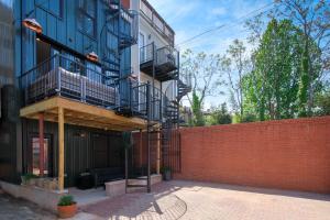 a building with a brick wall and a fire escape at 2BR Capitol hill delight, with private parking in Washington