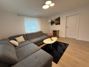 a living room with a couch and a table at Ferienwohnungen Bella in Reutte