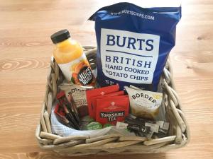 a basket filled with food and drinks on a table at Station House in Hornsea +15 photos
