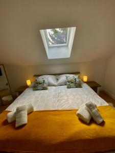 a bedroom with a bed with two towels on it at Filuma Suite with private terrace and balcony PANORAMIC GACKA VIEW in Otočac