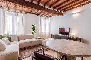a living room with a couch and a table at Fumo di Lambrusco - Rua Frati 34 - Boutique Apartment in Modena