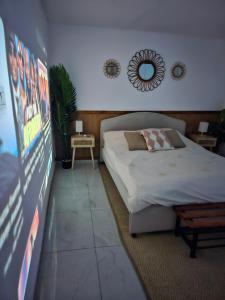 a bedroom with a bed and a large screen at Panda house by the sea in Qiryat Yam