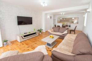 a living room with a couch and a table at GALIOT Apartment in Škaljari