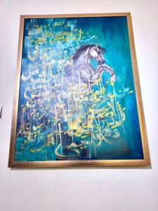 a painting of a horse on a wall at Heaven Four Suites in Karachi