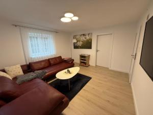 a living room with a couch and a table at Ferienwohnungen Bella in Reutte