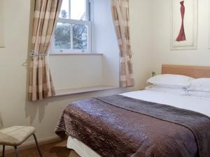 En eller flere senge i et værelse på 1 Brantfield House Bowness