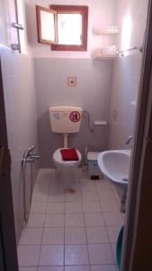 a bathroom with a toilet and a sink at Anemos Studios in Vassilias +74 photos