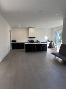 a large kitchen and living room with a couch at Cozy Suite in Brand New Luxury Home in Toronto