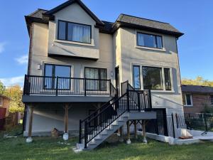 a house with a staircase in front of it at Cozy Suite in Brand New Luxury Home in Toronto