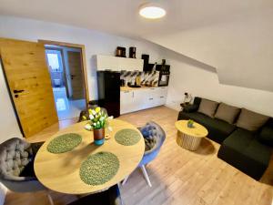 a living room with a table and a couch at Filuma Suite with private terrace and balcony PANORAMIC GACKA VIEW in Otočac