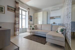a living room with a couch and a kitchen at Garden view Rooftop in Castellammare di Stabia +14 photos