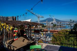 a balcony with a view of a harbor and a boat at Garden view Rooftop in Castellammare di Stabia