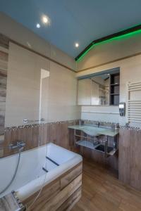 a bathroom with two sinks and a bath tub at Garden view Rooftop in Castellammare di Stabia