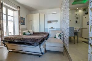 a bedroom with a bed and a couch and a chair at Garden view Rooftop in Castellammare di Stabia