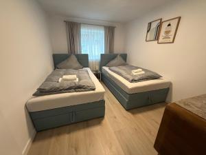 een slaapkamer met twee bedden en een raam bij Ferienwohnungen Bella in Reutte