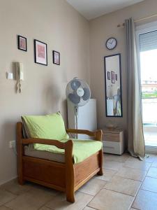 a bedroom with a bed and a fan and a window at Feels like home in Maniákoi