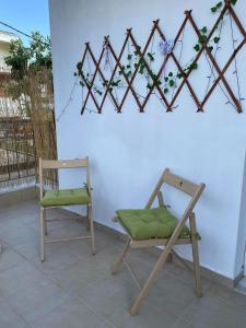 a couple of chairs sitting in front of a wall at Feels like home in Maniákoi