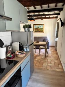 a kitchen with a counter and a dining room at Alloggio Turistico LA TORRE in Acquapendente