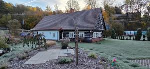 a small house with a garden in front of it at Poloroubenka Podkrkonoší in Bělá