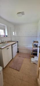 a kitchen with a sink and a bath tub at Poloroubenka Podkrkonoší in Bělá +2 photos