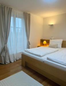 a bedroom with a large bed and a window at Chalet close to the Clouds in Špindlerův Mlýn +45 photos