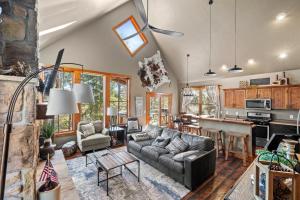 a living room with a couch and a kitchen at 4 bedroom Cabin In Black Hills with Hot tub and Heated Pool in Lead