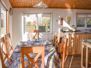 a dining room with a table and chairs in a kitchen at Tranquillity in Millom