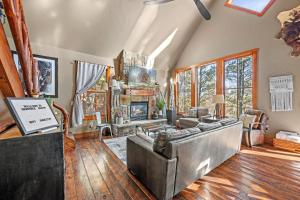 a living room with a couch and a fireplace at 4 bedroom Cabin In Black Hills with Hot tub and Heated Pool in Lead