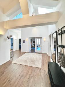 ein Wohnzimmer mit weißen Wänden und Holzböden in der Unterkunft Auszeit im Chiemgau, Ferienwohnungen in Rottau