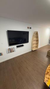 a living room with a large flat screen tv on a wall at Lagarto Playas Majoreras in Las Playas