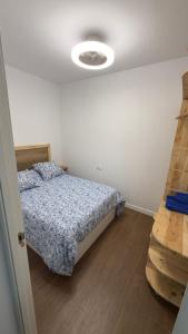 a bedroom with a bed and a light on the ceiling at Lagarto Playas Majoreras in Las Playas