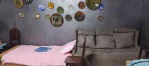 a bedroom with a couch and plates on the wall at Шишкарівський in Sumy