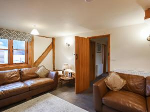 a living room with a couch and a table at Uk46578 - Drifthouse in Church Stretton
