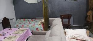 a living room with a couch and a bed at Шишкарівський in Sumy