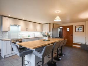 a kitchen with a wooden table and chairs at Uk46578 - Drifthouse in Church Stretton