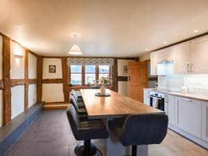 a kitchen with a wooden table and chairs at Uk46578 - Drifthouse in Church Stretton