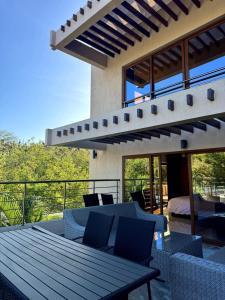 a patio with a table and chairs on a balcony at 5-Bedroom Luxury Villa with Pool, Near Diani Beach in Diani Beach