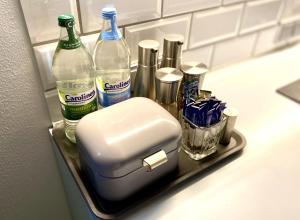 a bathroom counter with bottles of alcohol and a toaster at DESIGN LOFT Herford - Parkplatz, WLAN, Netflix, PS4, Heimkino in Herford