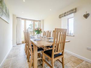 a dining room with a wooden table and chairs at Owl Barn -- Uk30757 in Bream +24 photos